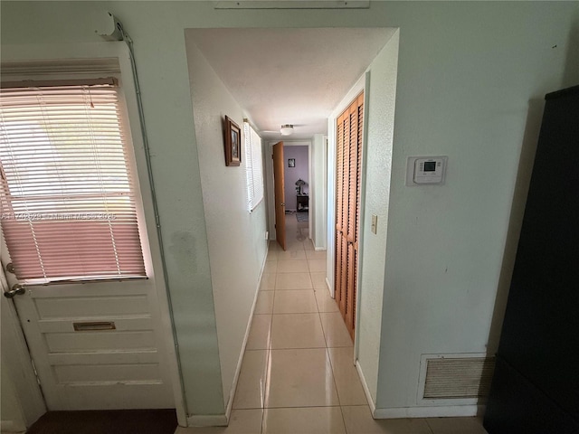 11277 SW 172nd St Unit I1742D, Miami, FL 33157 - hallway with light tile patterned floors and baseboards