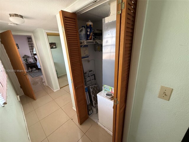 11277 SW 172nd St Unit I1742D, Miami, FL 33157 - hall with light tile patterned flooring and a textured ceiling