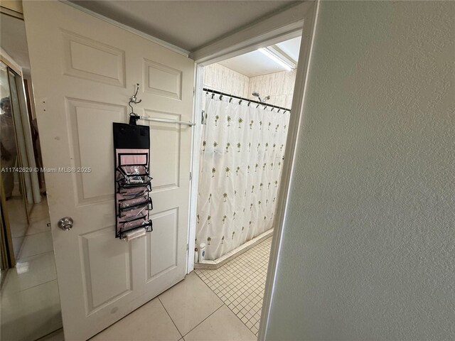 11277 SW 172nd St Unit I1742D, Miami, FL 33157 - hallway featuring light tile patterned flooring and a textured wall