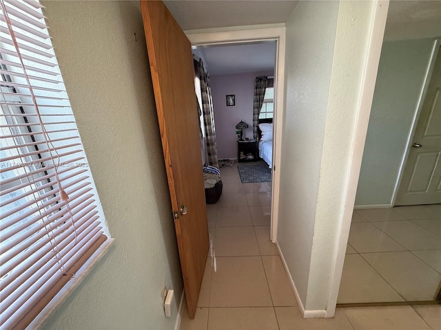 11277 SW 172nd St Unit I1742D, Miami, FL 33157 - hall with light tile patterned floors and a textured wall