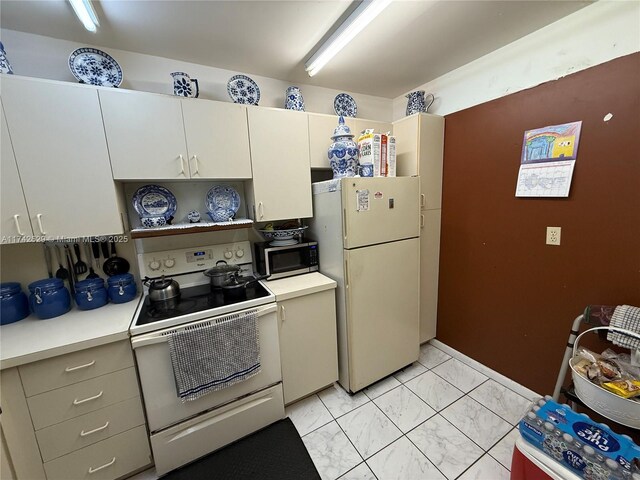 11277 SW 172nd St Unit I1742D, Miami, FL 33157 - kitchen with white appliances, light countertops, light marble finish flooring, and open shelves