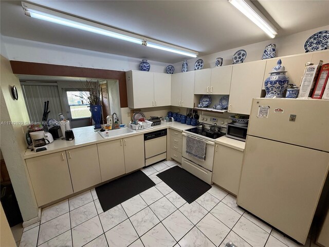 11277 SW 172nd St Unit I1742D, Miami, FL 33157 - kitchen with white appliances, light countertops, light marble finish floors, and white cabinetry