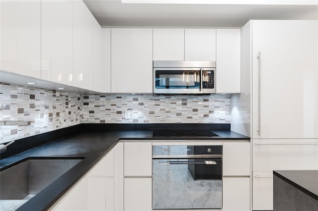 kitchen with sink, white cabinetry, backsplash, wall oven, and black electric cooktop