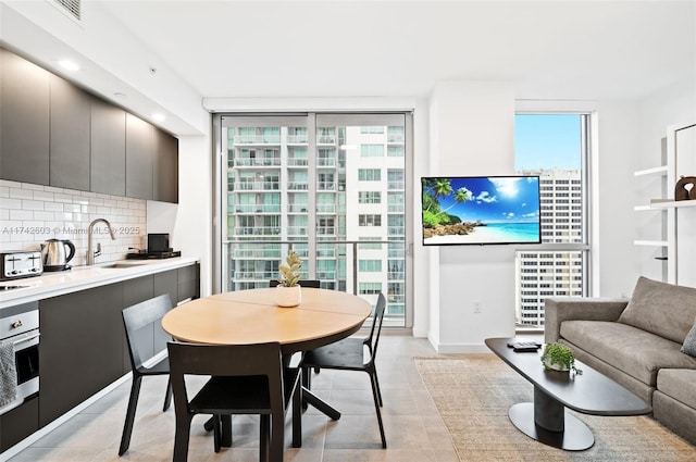 interior space with light tile patterned flooring, floor to ceiling windows, and plenty of natural light