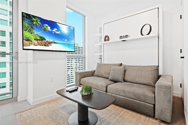 living room with a healthy amount of sunlight and a wall of windows