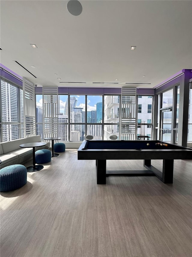 game room featuring hardwood / wood-style flooring and expansive windows