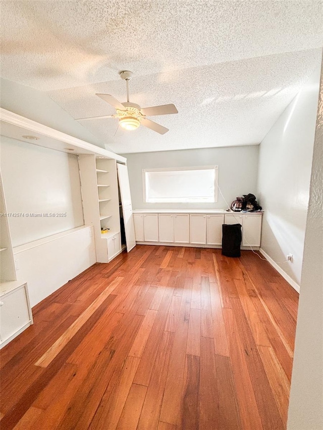 unfurnished bedroom with ceiling fan, hardwood / wood-style flooring, and a textured ceiling