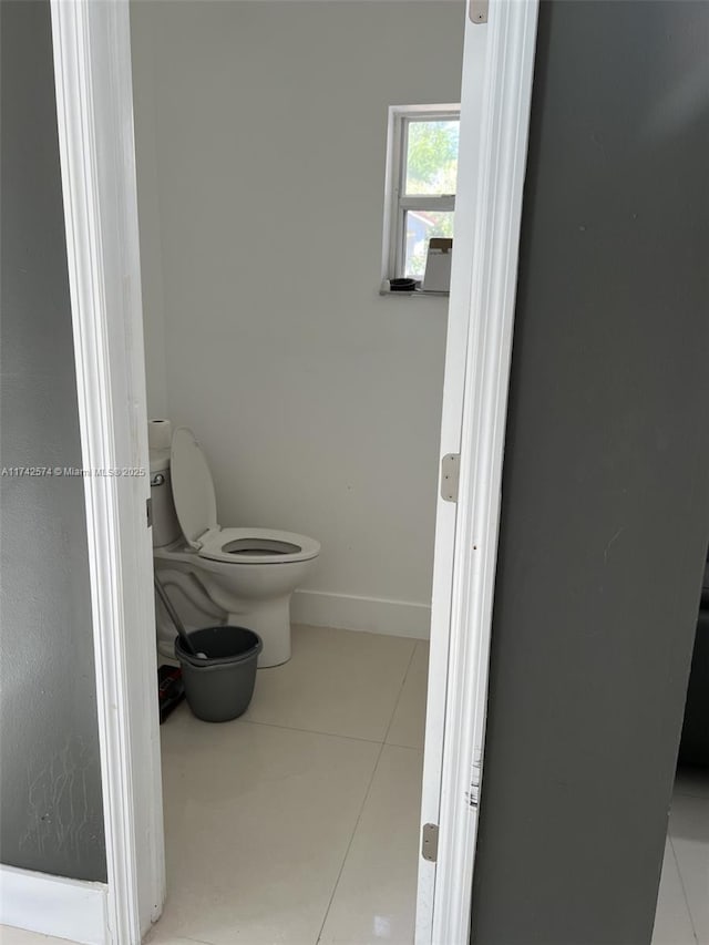 bathroom with tile patterned flooring and toilet