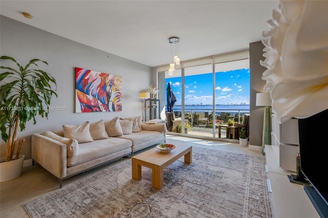 living area with a water view and expansive windows