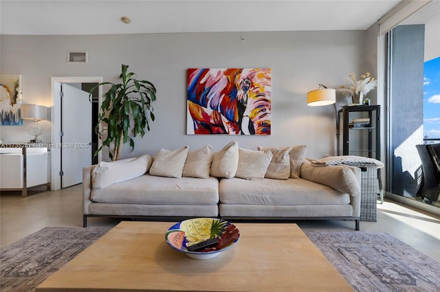 living room with concrete flooring and visible vents