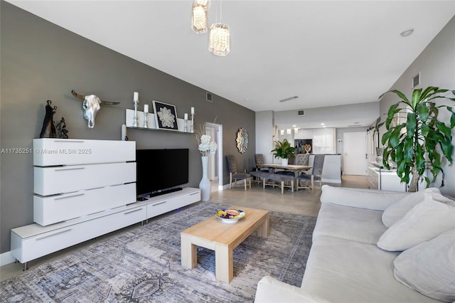 living room with baseboards, a chandelier, and visible vents