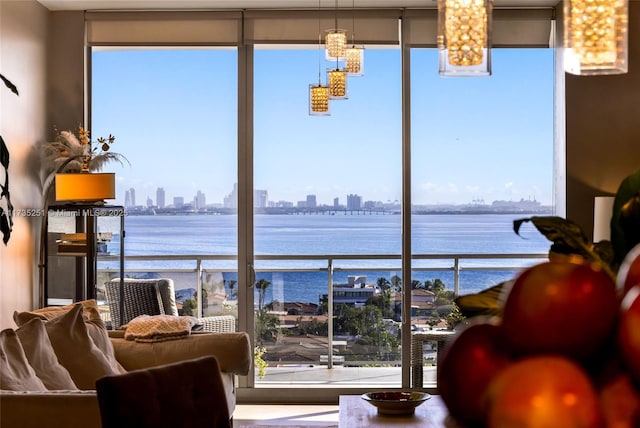 interior space featuring a water view, a city view, and a chandelier