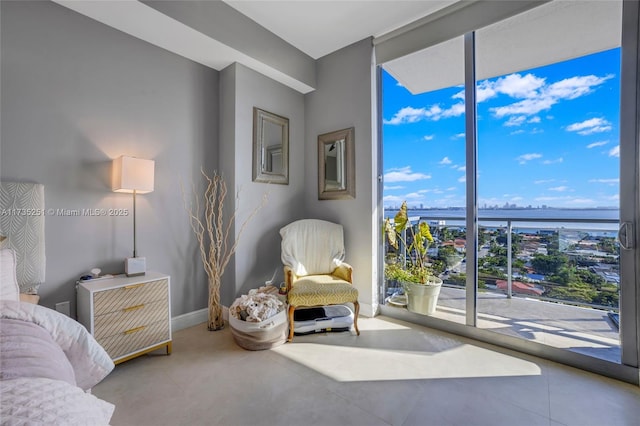interior space with baseboards and a water view
