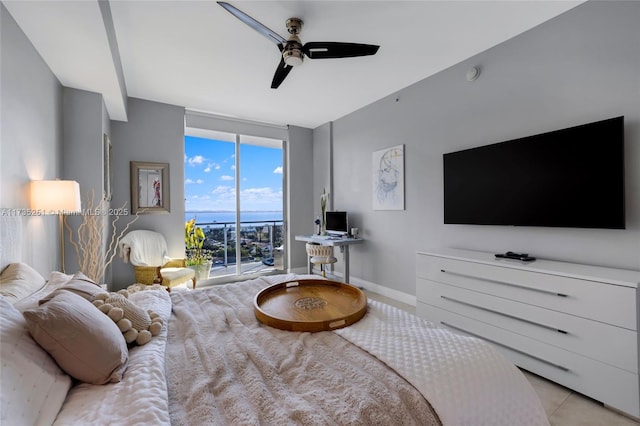 bedroom with access to outside, a ceiling fan, floor to ceiling windows, and baseboards
