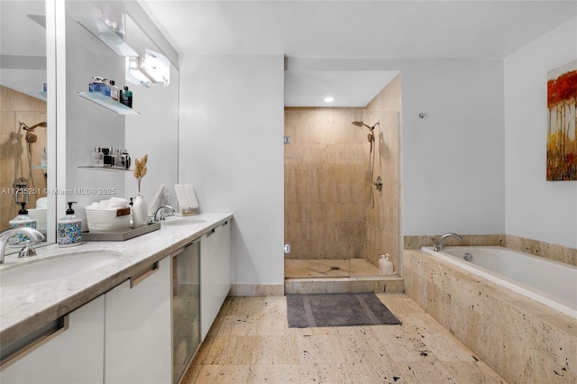 bathroom with a garden tub, a sink, double vanity, and a shower stall