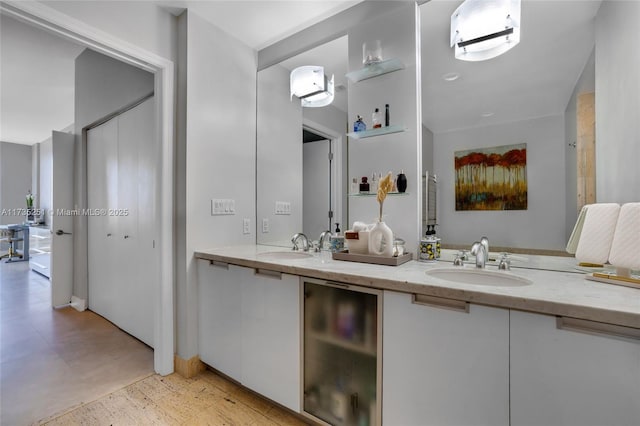 full bath with a sink, tile patterned floors, and double vanity