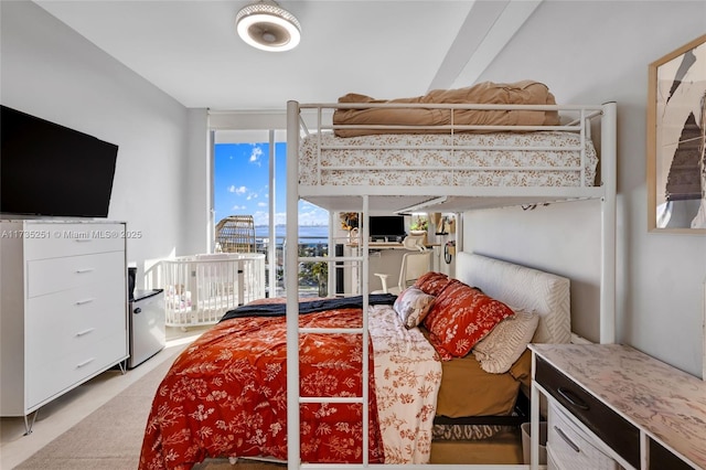 bedroom featuring light colored carpet