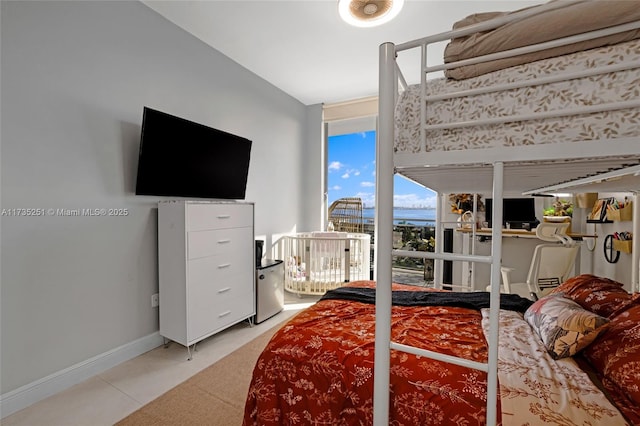 bedroom with baseboards and light tile patterned floors