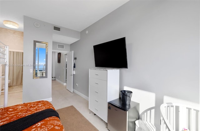 bedroom with fridge, baseboards, and visible vents