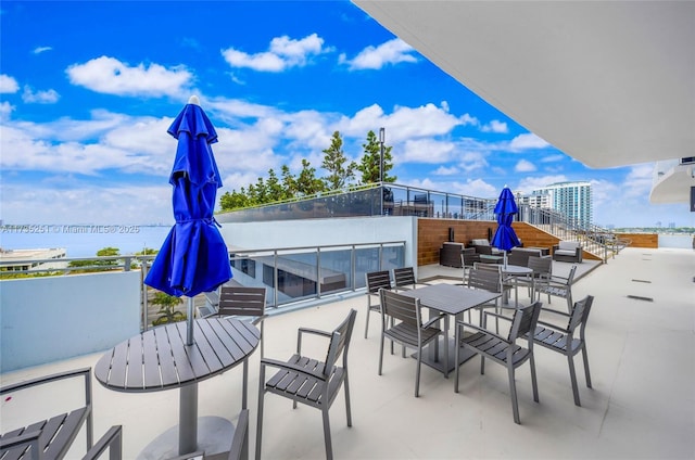 view of patio / terrace featuring outdoor dining area and a water view