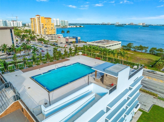 birds eye view of property featuring a city view and a water view
