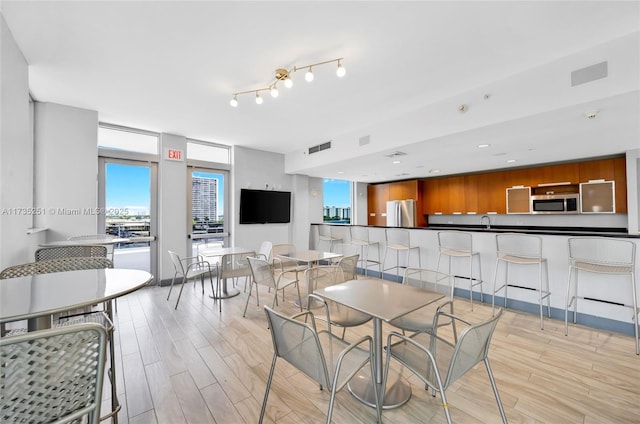 dining room featuring light wood-style floors and visible vents