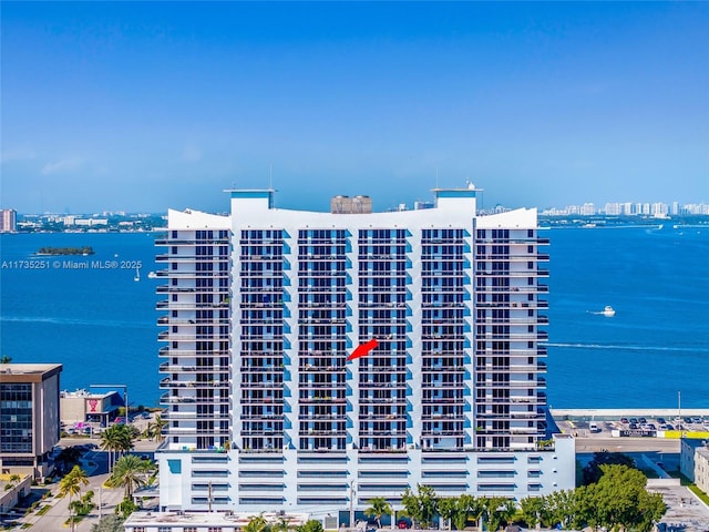 view of building exterior with a view of city and a water view