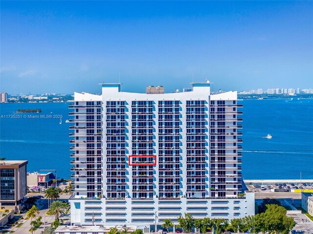 view of building exterior with a water view and a city view
