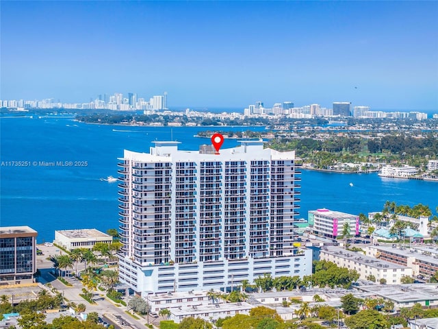 drone / aerial view featuring a water view and a city view