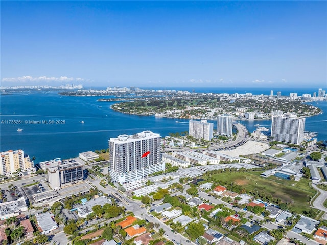 birds eye view of property featuring a view of city and a water view