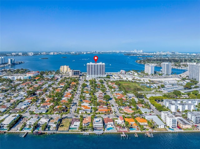 birds eye view of property with a view of city and a water view