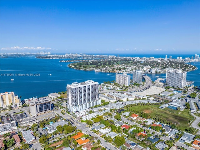 drone / aerial view featuring a water view and a city view