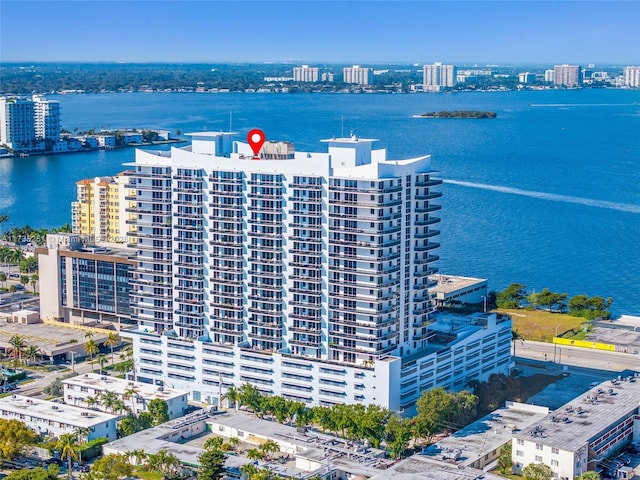 drone / aerial view featuring a water view and a view of city