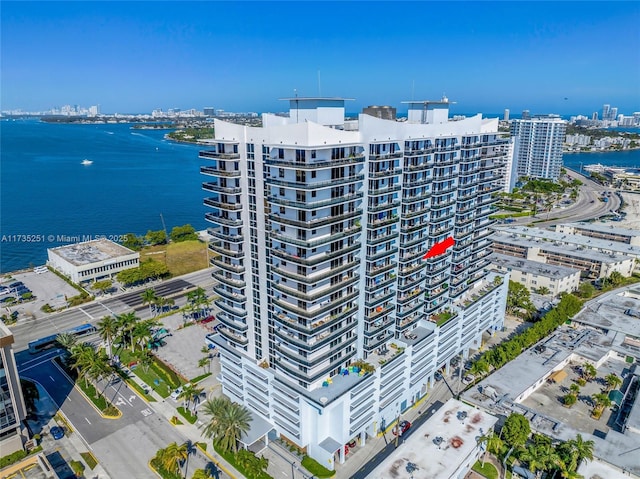 drone / aerial view featuring a water view and a city view