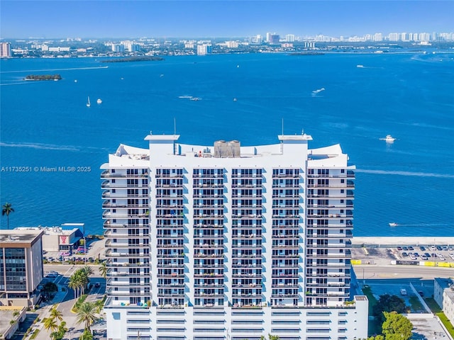 birds eye view of property with a view of city and a water view