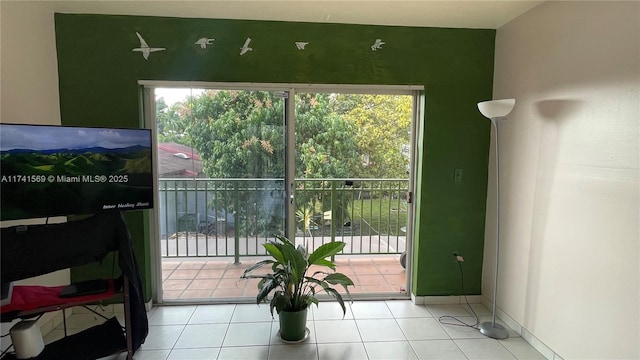 doorway to outside with light tile patterned floors