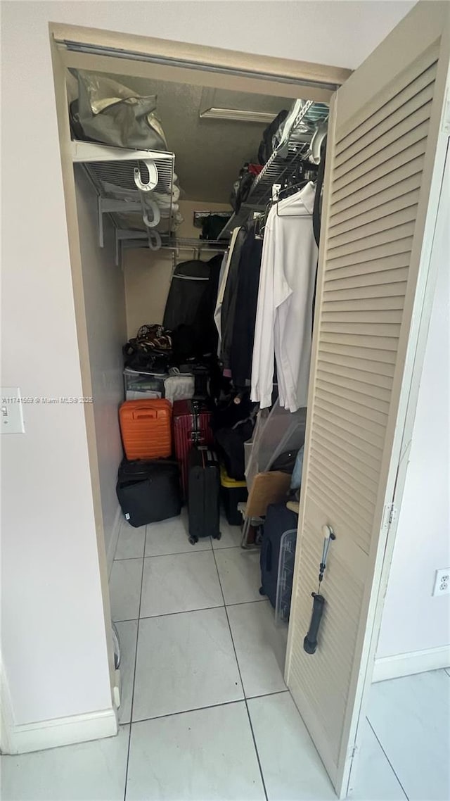 walk in closet with light tile patterned floors