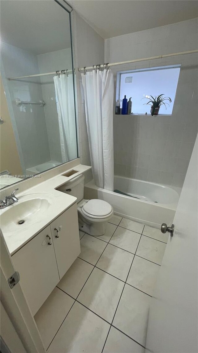 full bathroom with vanity, toilet, tile patterned floors, and shower / tub combo with curtain