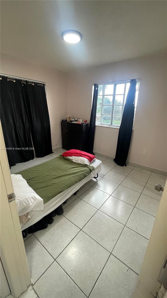 bedroom featuring light tile patterned flooring