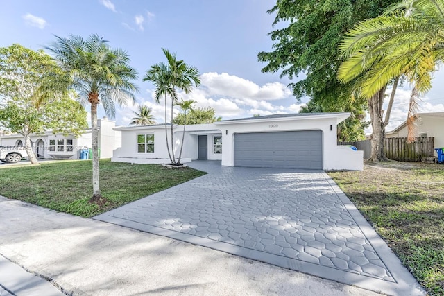 view of front of property with a garage and a front yard