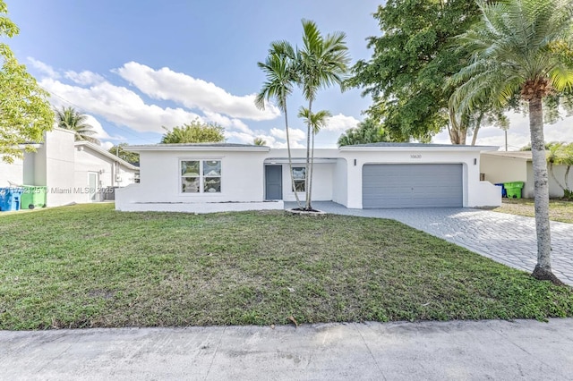 single story home with a garage and a front yard