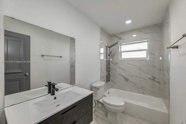 full bathroom featuring vanity, tiled shower / bath combo, and toilet