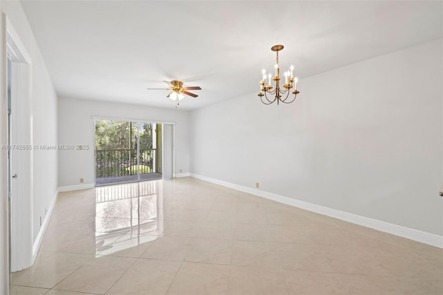 tiled spare room with ceiling fan with notable chandelier