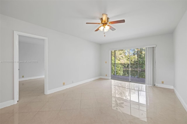 tiled empty room featuring ceiling fan