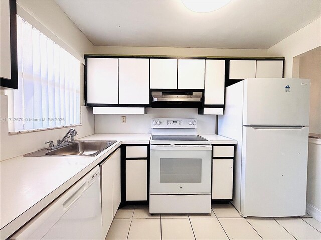 kitchen featuring sink, white appliances, light tile patterned floors, and white cabinets