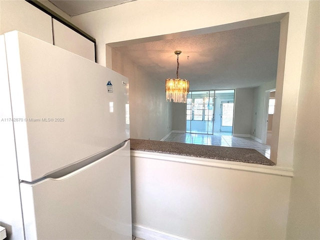 interior space with an inviting chandelier and white fridge