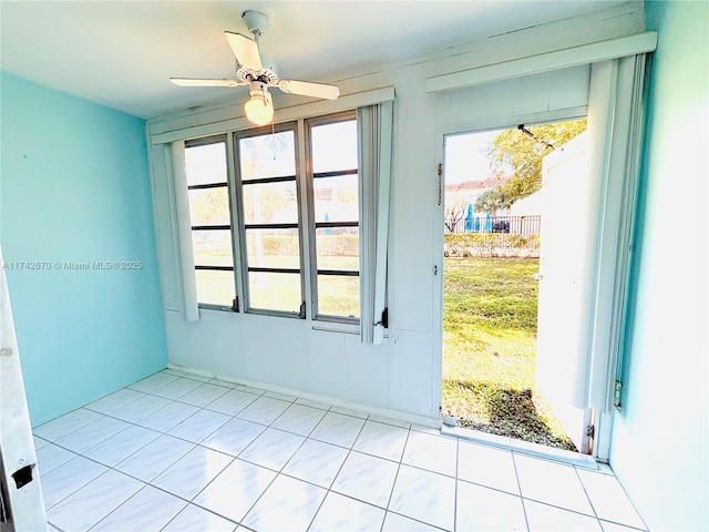 spare room with ceiling fan and a healthy amount of sunlight