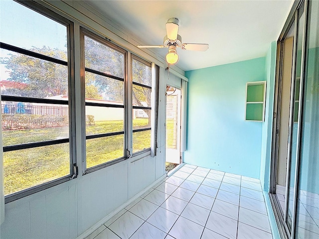 unfurnished sunroom with ceiling fan