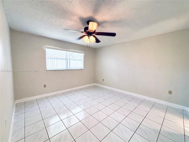 empty room featuring ceiling fan and a textured ceiling