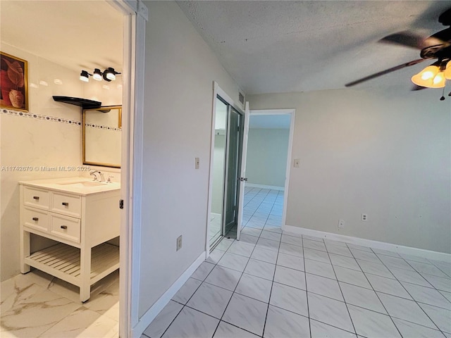 interior space featuring sink and a textured ceiling